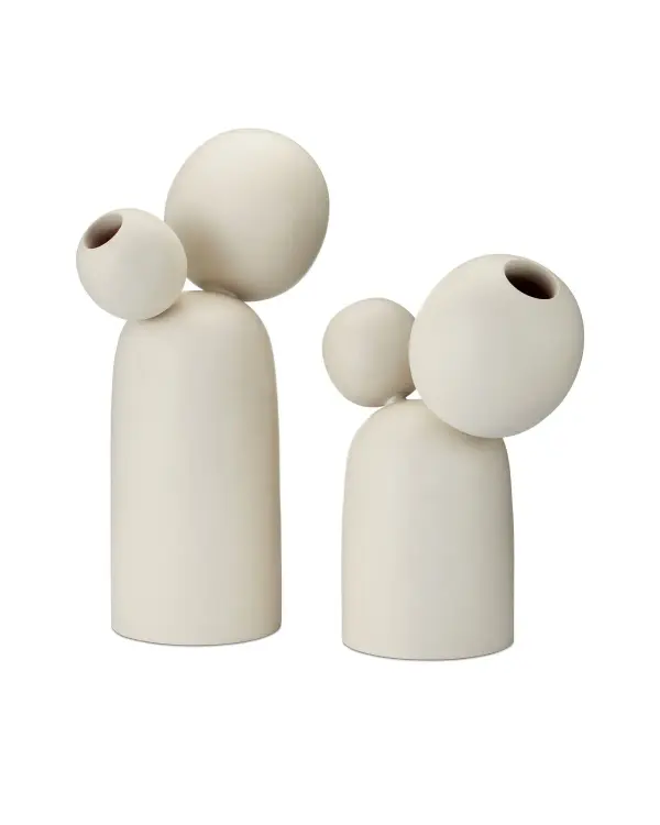 These ivory mango wood sculptures bring contemporary elegance with their geometric profiles and staggered sizing. Perfect for creating curated vignettes on shelves, mantels, or console tables.