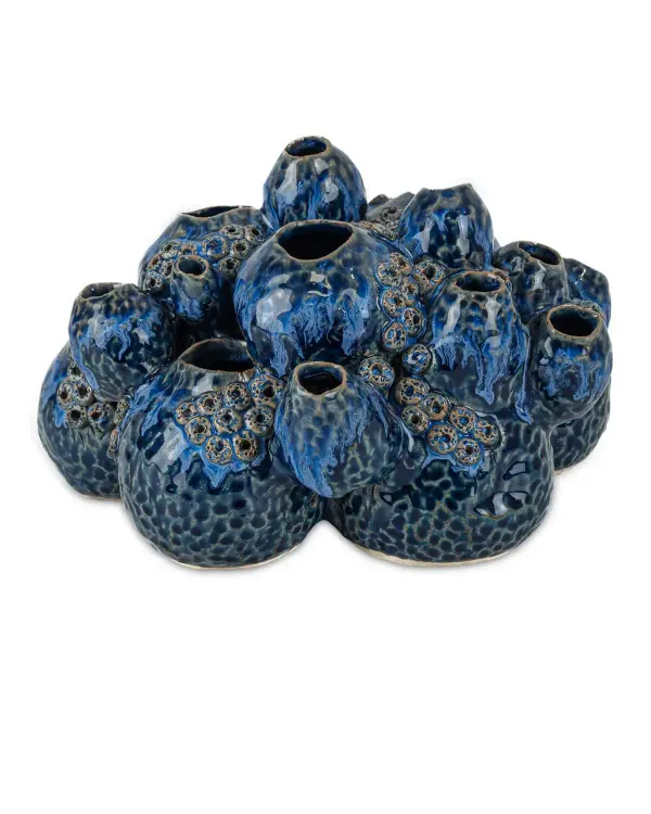 This handcrafted ceramic sculpture captures coastal beauty with its barnacle-inspired design and deep blue reactive glaze. Each piece is individually thrown and carved, making it truly one-of-a-kind with organic texture and visual interest.