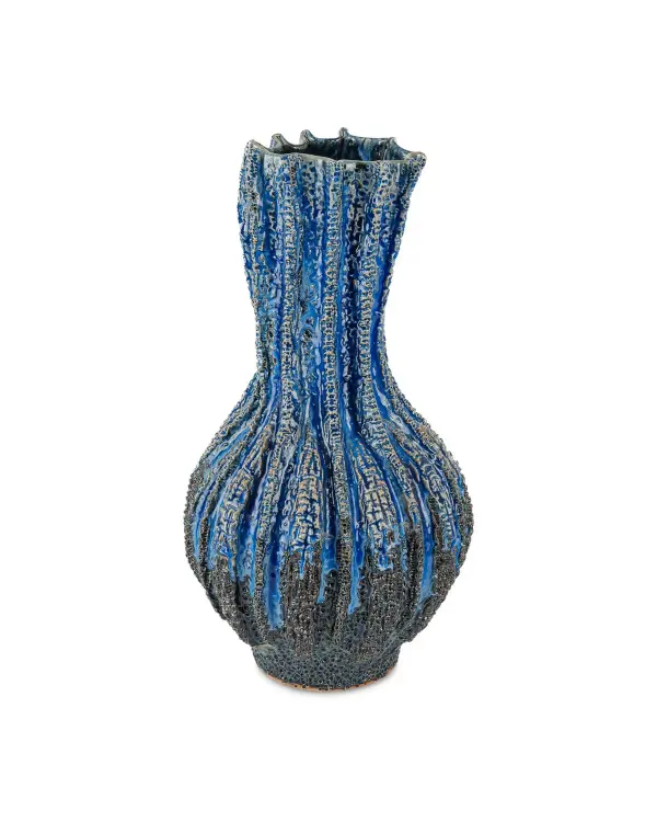 The Folios Vase showcases exceptional craftsmanship with hand-pressed textures and a stunning reactive dark blue glaze. Its organic form and unique surface variations make it a standout decorative accent that adds depth and artisanal character to any space.