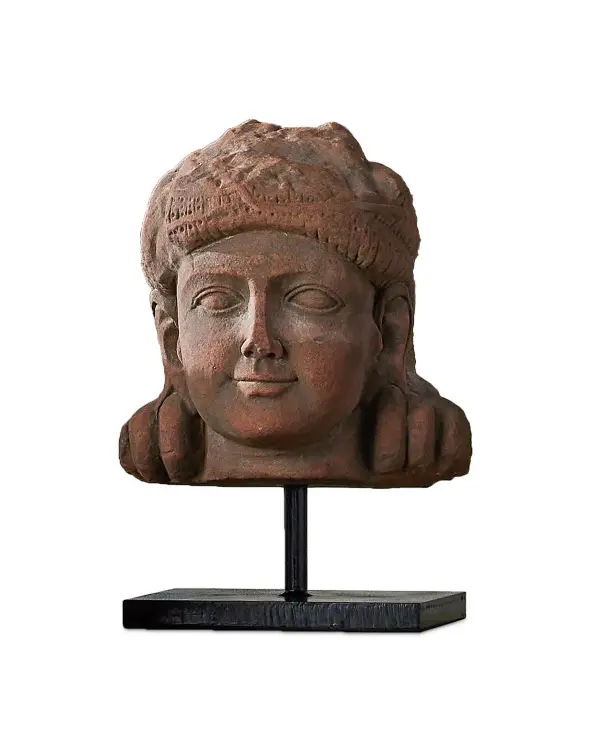 This handcrafted stone head sculpture brings cultural depth and artistic presence to any space. Mounted on an antique brass base, it serves as a sophisticated focal point that bridges traditional craftsmanship with contemporary interiors.