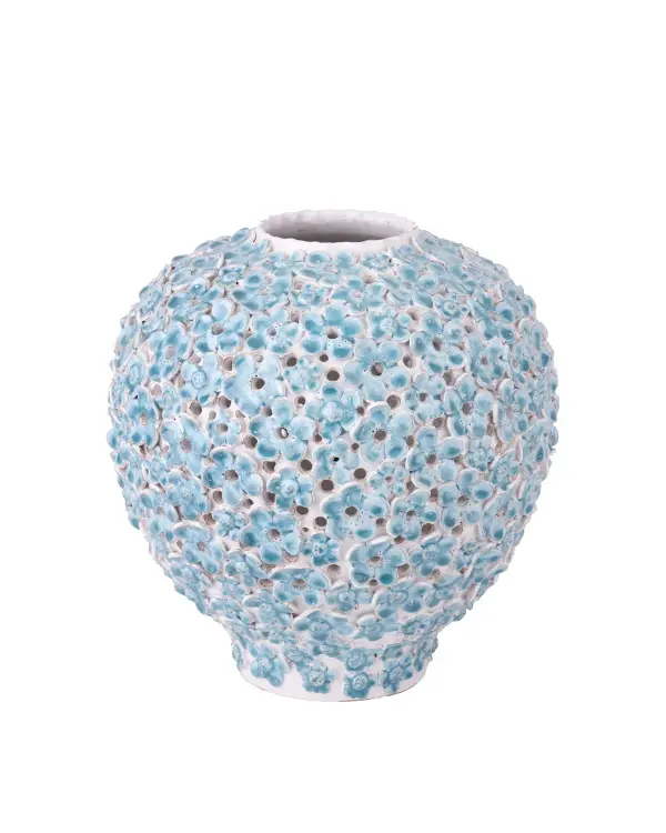 This artisan-made ceramic vase showcases hand-placed forget-me-not flowers and intricate pierced detailing. Its handcrafted nature ensures each piece is unique, making it a distinctive decorative accent for coastal or organic modern interiors.