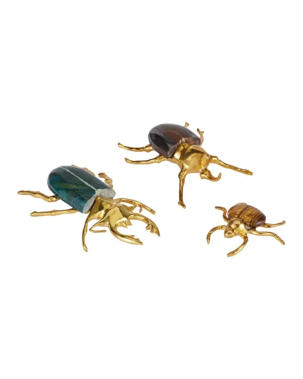 A striking decorative set featuring three brass beetles with natural gemstone bodies—Green Aventurine, Tiger Iron, and Tiger Eye. Each piece showcases artisanal craftsmanship with polished brass detailing and unique stone patterns.