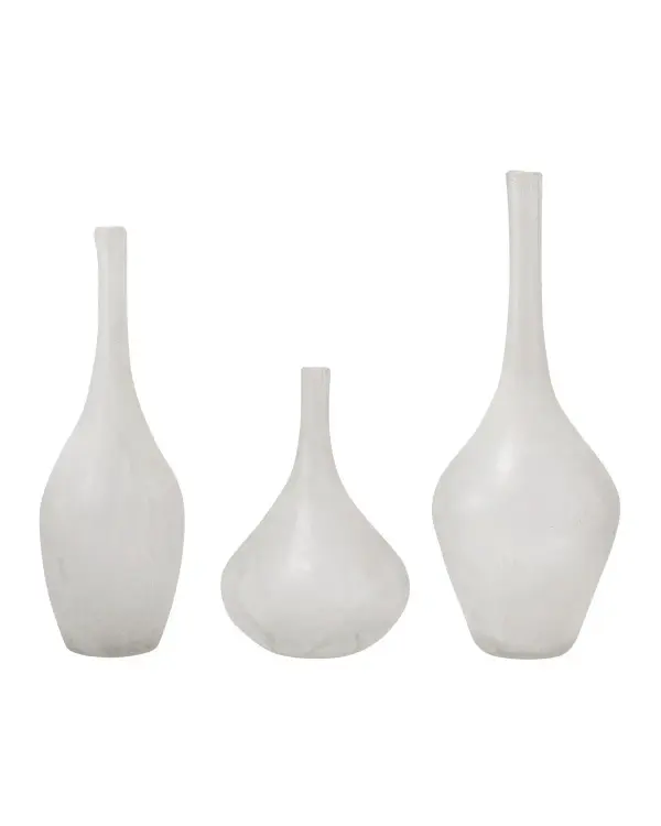 This three-piece vase set showcases handcrafted glass with an intentional soda-fired finish that creates an aged, organic aesthetic. Each piece features unique variations in color and texture, making every set one-of-a-kind.