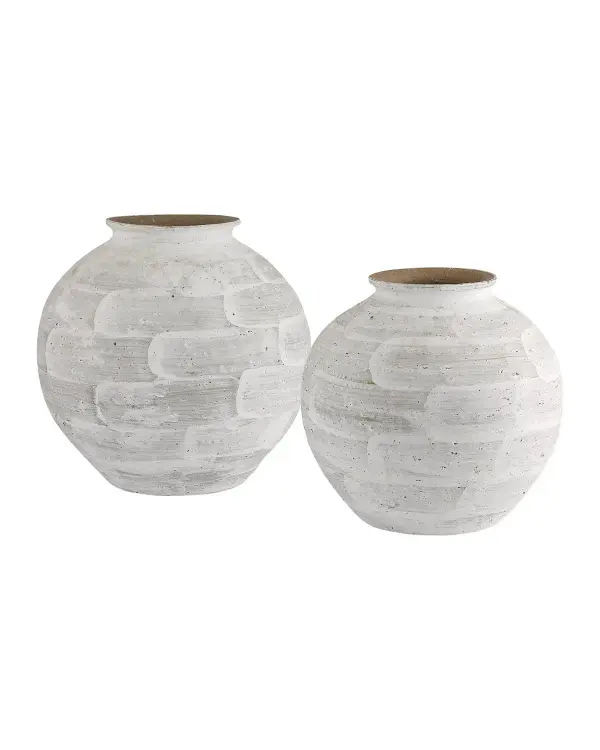 These hand-thrown porcelain vases bring organic texture and artisanal charm to any space. The roughly applied white glaze with bold brushstrokes creates a rustic, sculptural presence that works beautifully in modern and coastal interiors.