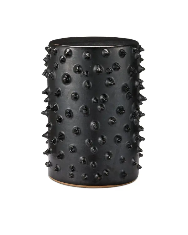 This artisan-made ceramic table features distinctive hand-applied dimpled texture and weather-resistant black glaze. Its compact footprint and sculptural presence make it ideal for layering texture in both interior and exterior spaces.