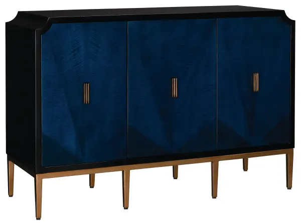 The Kallista Blue Cabinet has a dark sapphire blue finish that enlivens the sycamore veneers on its door fronts. The wood grains bring the cabinet a hint of distressing that contrasts the sleek lines of the base and door pulls in an antique brass finish. The exterior is finished in a glossy caviar black. Design details on this navy blue cabinet include soft-close door hinges, and adjustable shelves and glides. Collection: Kallista Finish: Dark Sapphire/Caviar Black/Antique Brass Width: 54.00" Height: 36.00" Length: 19.00" Weight: 174.00 lb Material: Sycamore Veneer / Mahogany / Engineered Hardwood / Brass / Iron Country of Origin: Indonesia Manufacturer Warranty: Warrants products for 1 yr against defects in materials & workmanship
