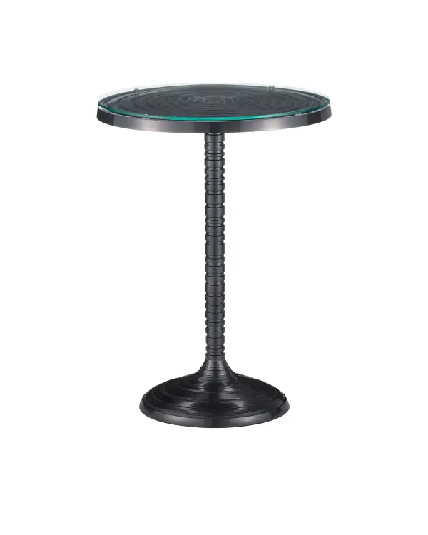 The Erno Accent Table brings industrial sophistication with its gear-inspired turned column and concentric circle detailing. Cast aluminum construction with black nickel finish offers durability and visual weight, while the clear glass top adds lightness.