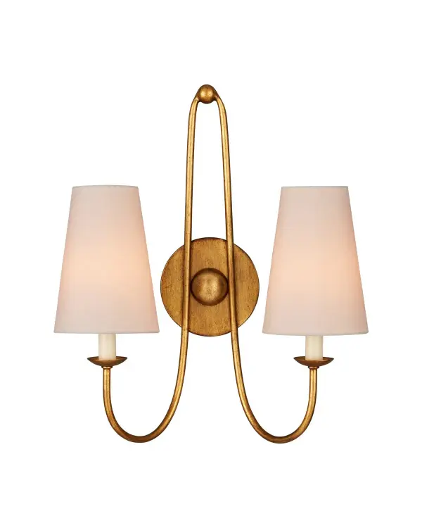 The Brayden wall sconce combines classic design with refined materials. Its burnished gold leaf finish and looping arms create a sophisticated look, while fabric shades soften the light for ambient warmth.