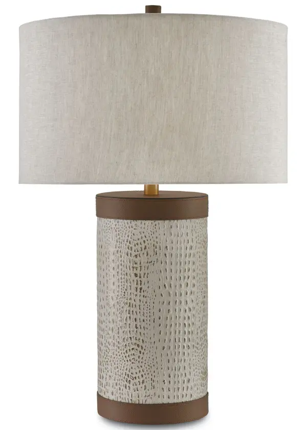 The Baptiste Table Lamp brings refined texture and warmth through genuine crocodile-embossed leather paired with brushed brass accents. Its natural linen shade softens the light while the rich leather column adds tactile luxury to any space.