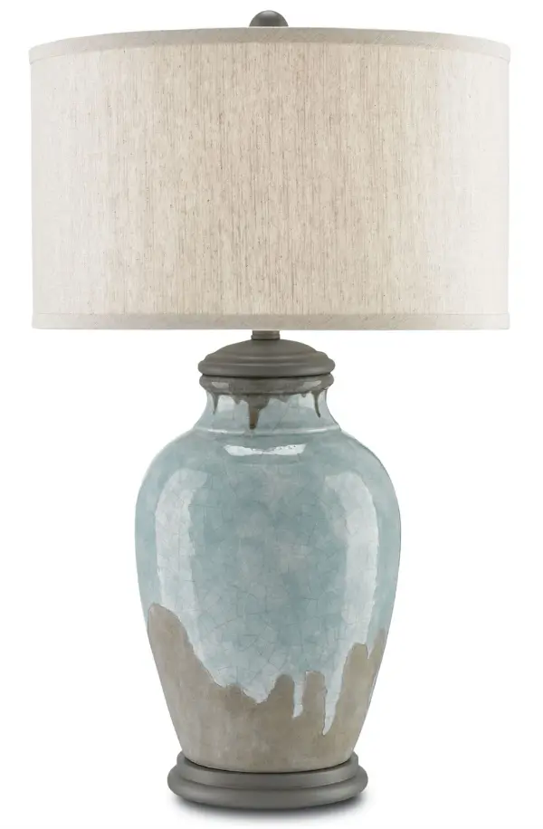 A sophisticated table lamp featuring handmade terracotta with flowing blue-green glaze over gray base. The ginger-jar silhouette with crackle finish and wood accents creates textural depth, while the oatmeal linen shade softens the light.