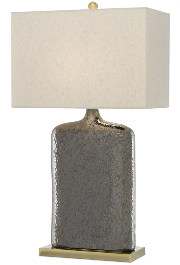The Musing Table Lamp combines handcrafted ceramic artistry with functional lighting. Its flask-like silhouette features natural pitting in the rustic metallic bronze glaze, creating organic texture. The elongated body and bronze plinth base pair beautifully with the khaki linen shade for sophisticated warmth.