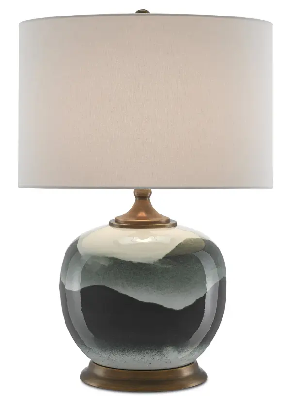 This sophisticated table lamp features a hand-glazed porcelain body with undulating green patterns that bring organic beauty to any space. The classic ginger jar silhouette pairs beautifully with antique brass accents and a crisp white linen shade.