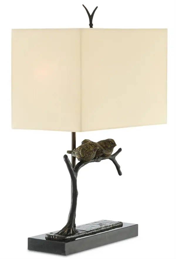A whimsical brass table lamp featuring hand-cast birds perched on an arching branch with twig finial. The bronze finish paired with black marble base creates sophisticated contrast, while the honey beige shade provides warm ambient lighting.