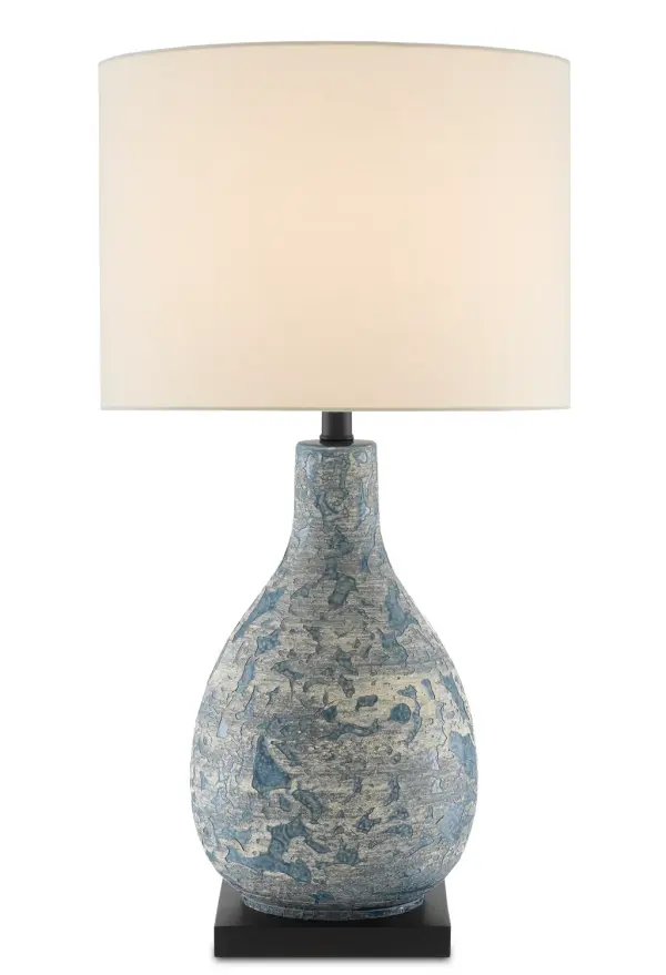 The Ostracon brings coastal elegance with its hand-glazed ceramic body featuring swirling blue patterns beneath gray and cream overlays. The ivory shantung shade complements the creamy tones while the black base grounds the design.