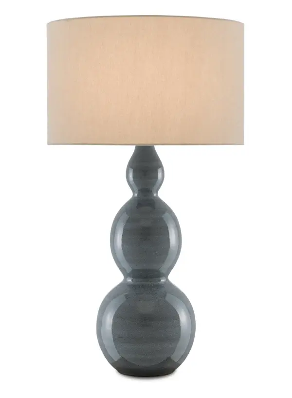 The Cymbeline brings refined elegance with its distinctive triple-gourd silhouette and delicately stippled steel blue ceramic body. The antique brass base and natural linen shade create a sophisticated balance of traditional form and contemporary finish.