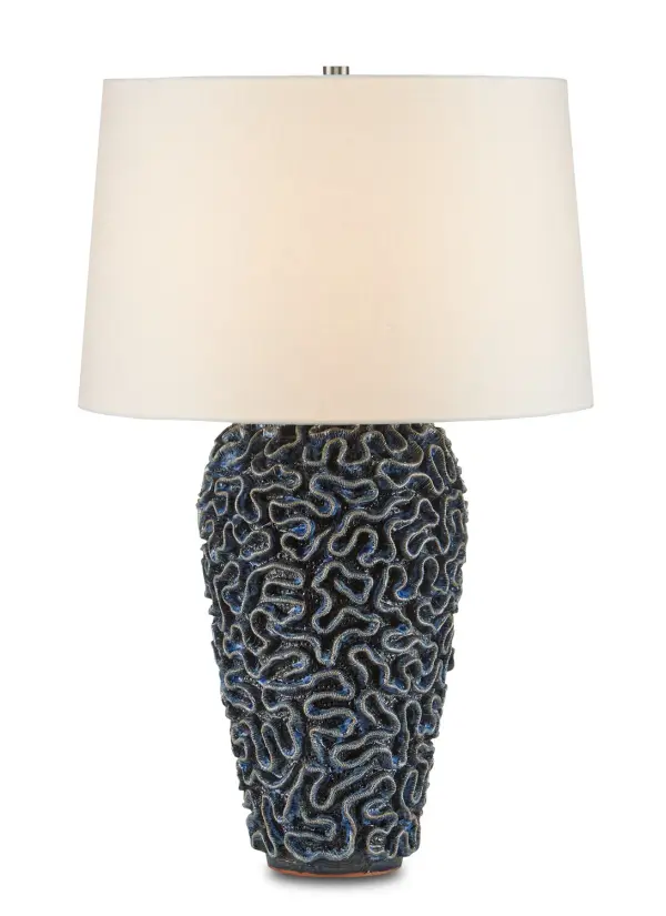 This striking table lamp showcases exceptional craftsmanship with its hand-thrown black terracotta base featuring a unique swirled surface reminiscent of brain coral. The rich reactive blue glaze creates depth and visual interest, while the artisanal production by women artisans at the Burma-Thailand border adds meaningful provenance to this coastal-inspired piece.