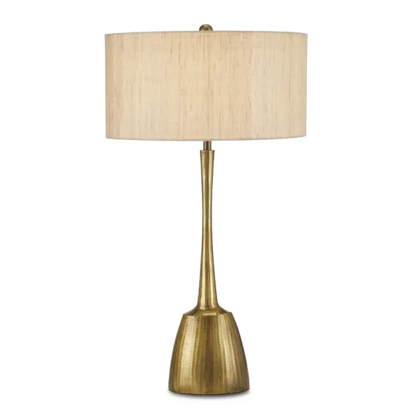 The Cheenee Table Lamp makes a striking statement with its brutalist-inspired design and gleaming antique brass finish. Hand-chiseled texture adds depth to the sculptural silhouette, while the natural linen shade softens the bold metalwork.