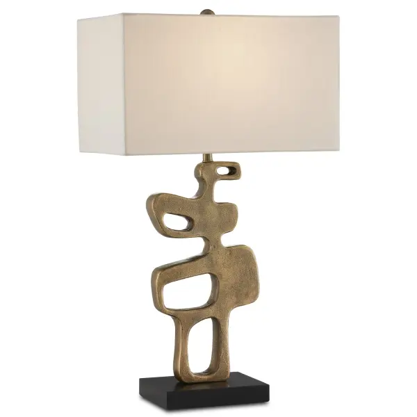 A striking table lamp that commands attention with its sculptural cast aluminum form and vintage-inspired antique brass finish. The brutalist aesthetic is balanced by refined elements like the honed granite base and clean shantung shade.