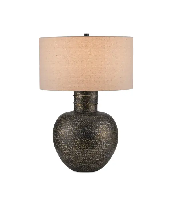 The Braille Table Lamp showcases artisanal metalwork with hand-applied antique brass finish over hammered aluminum. Its vase-shaped silhouette and natural linen shade create warm, textured lighting for traditional and transitional interiors.