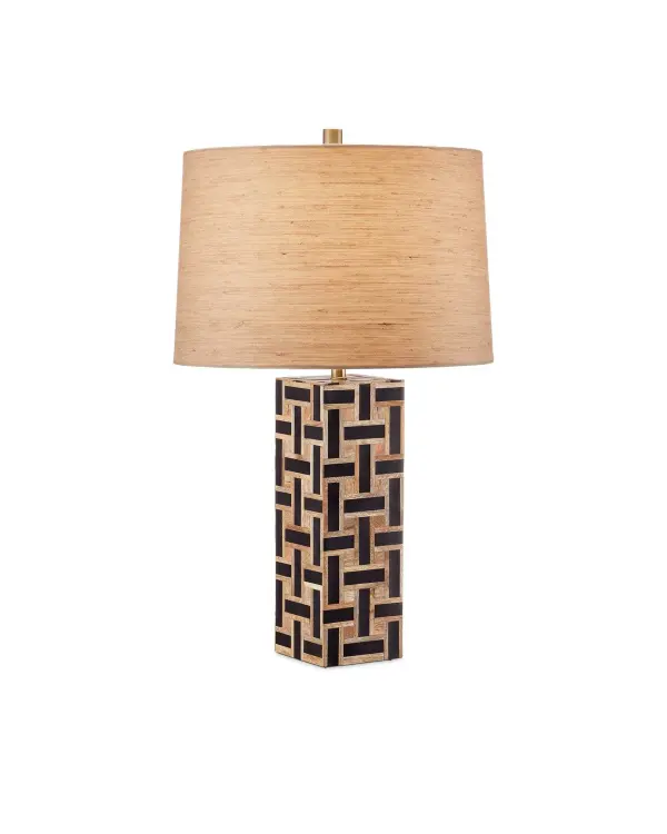 The Aarna table lamp showcases artisanal craftsmanship with its intricate basketweave pattern combining natural wood and black composite strips. The angular rectangular form and textural surface create visual interest while the drum shade balances the design complexity.