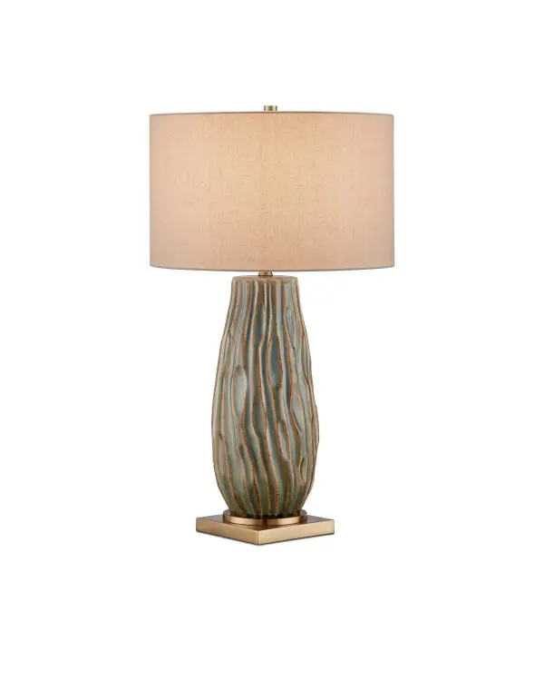 This artful table lamp features a ceramic base with undulating peaks and valleys reminiscent of flowing water. The forest reactive glaze creates unique green and tan variations across each piece, making every lamp one-of-a-kind.