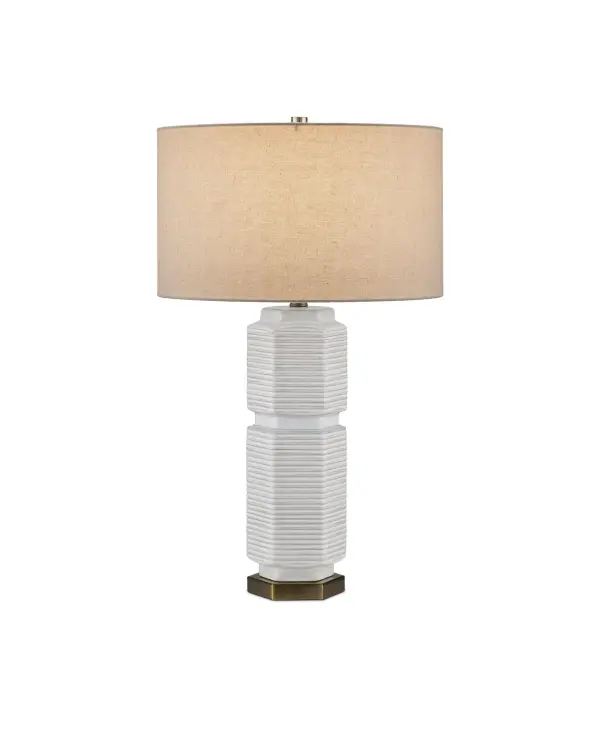 The Glebe Table Lamp combines geometric sophistication with subtle coastal charm. Its hexagonal ceramic body features delicate striated textures and soft white glaze with hints of beige and blue, complemented by warm antique brass accents.