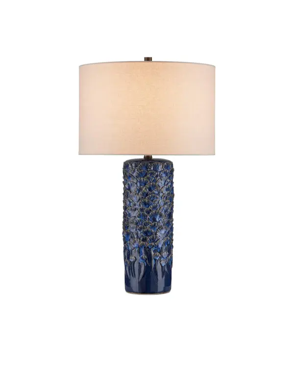 A stunning statement piece featuring handmade gingko leaves applied by skilled artisans. The dark blue reactive glaze creates unique variations on each lamp, making every piece one-of-a-kind. Perfect for adding organic texture and coastal elegance.
