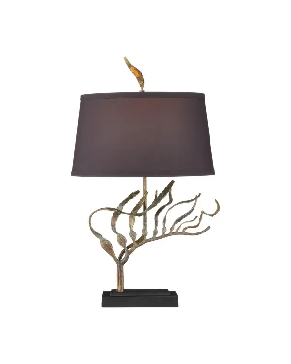 A striking brass table lamp featuring fluid kelp-inspired extensions with verdigris patina. The sculptural design pairs organic coastal elegance with artisan craftsmanship, while the gold-lined shade creates warm ambient lighting.