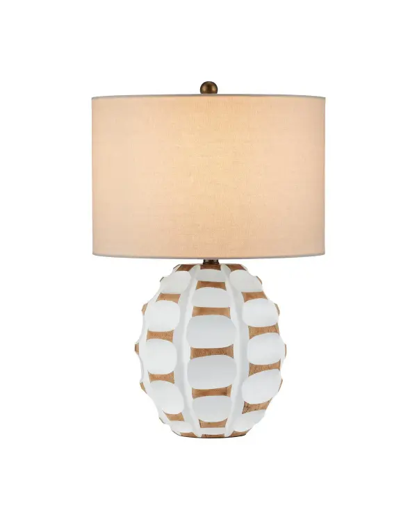 This artisanal table lamp showcases hand-carved mango wood with a distinctive raised disc pattern. The white-painted lozenges contrast beautifully with natural wood tones, creating organic visual interest that works in coastal and modern spaces alike.