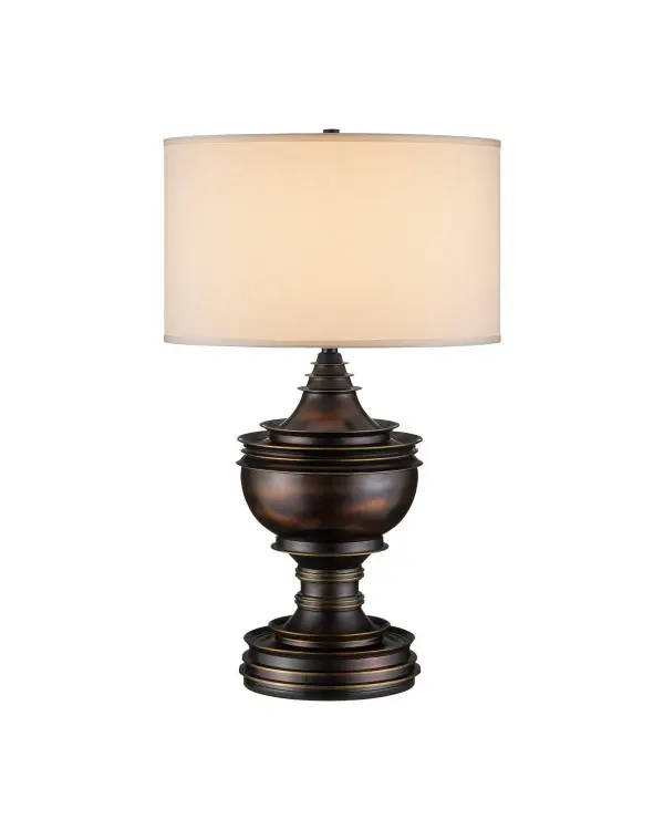 The Tribute Table Lamp brings ceremonial elegance to modern interiors with its distinctive vessel-inspired form. Crafted in bronze with brass-like rubbed edges, this substantial piece commands attention while the soft cotton silk shade provides warm, inviting light.