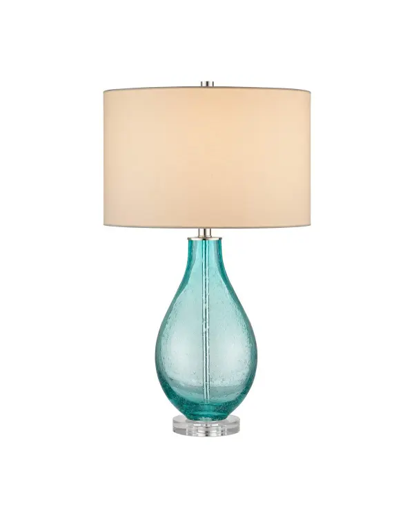 The Mavi Table Lamp brings oceanic beauty indoors with seeded glass that mimics underwater effervescence. Its elegant teardrop silhouette and spa blue-green hues create a serene coastal atmosphere while maintaining modern architectural clarity.
