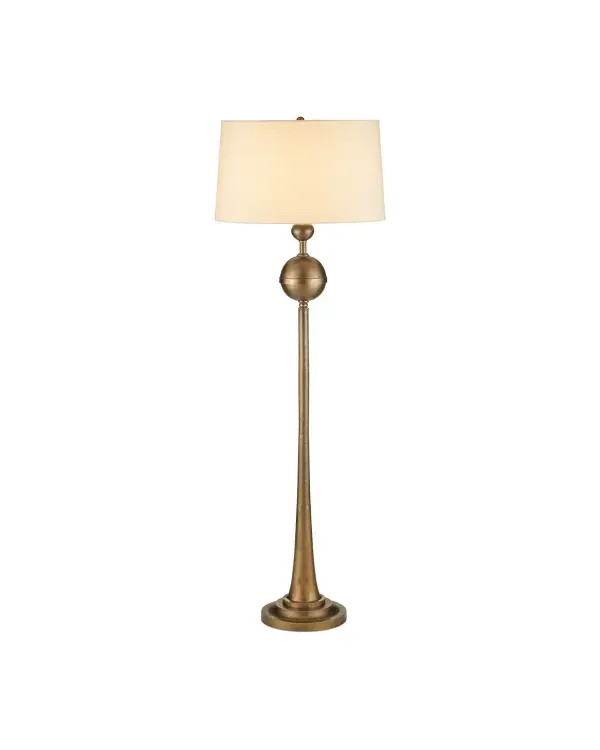 The Boullee floor lamp combines traditional craftsmanship with contemporary form. Its cast aluminum construction in antique brass finish features a distinctive trumpet-shaped base that serves as both structural support and sculptural element.