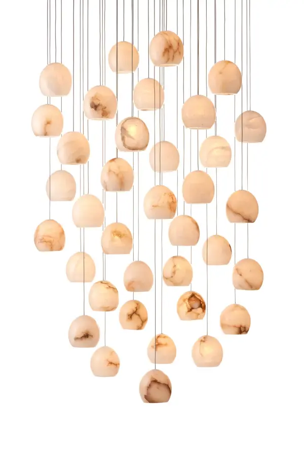 A dramatic multi-drop pendant featuring 36 hand-carved alabaster shades with unique natural veining. The painted silver canopy complements the luminous white stone, creating an elegant focal point for grand spaces.