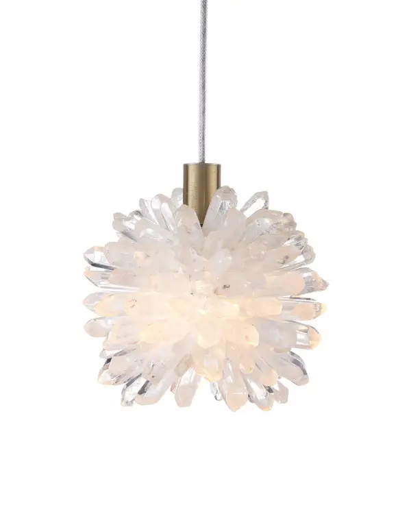A compact statement piece featuring natural quartz crystal spikes that create dramatic light reflection. The textural quality and organic form bring sculptural interest to small spaces while the brass accents add warmth.