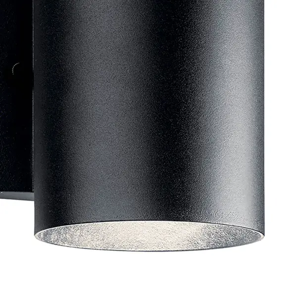This compact cylinder wall sconce combines energy-efficient integrated LED technology with Dark Sky compliance, making it ideal for eco-conscious homeowners. The textured black finish and clean lines suit contemporary exteriors. - alternate view