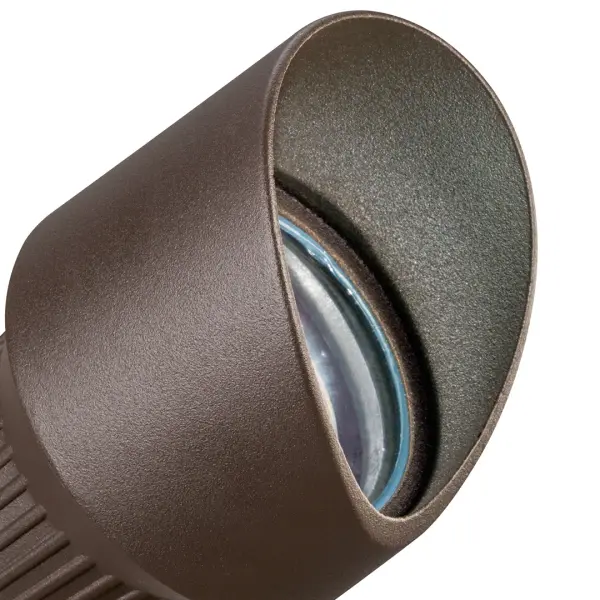 This compact 12V landscape spotlight delivers focused illumination for architectural features, landscaping, and pathways. The textured architectural bronze finish provides durability and blends naturally with outdoor environments. - alternate view