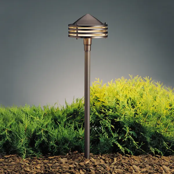 The Galaxy path light delivers sophisticated outdoor illumination in a compact, understated design. Its textured bronze finish and aluminum construction provide durability while maintaining clean contemporary lines.