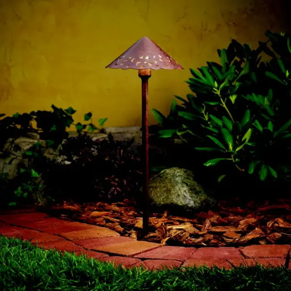 This compact landscape path light combines energy-efficient LED technology with an artistic hammered and pierced shade that casts beautiful decorative patterns. The textured bronze finish adds warmth and sophistication to outdoor spaces.
