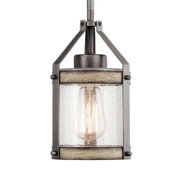 The Barrington Mini Pendant delivers authentic industrial style in a compact 5.5-inch format. Its anvil iron finish and clear seeded glass shade create visual interest while providing focused task lighting perfect for kitchen islands or intimate spaces. - alternate view