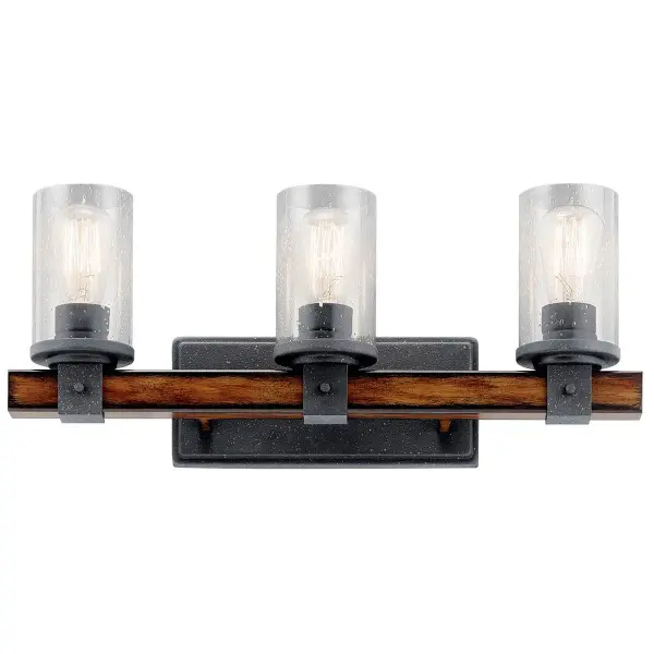 The Barrington 3-Light Vanity Light combines distressed black metal with clear seeded glass for authentic industrial style. At 22 inches wide, it provides ample illumination for medium vanities while adding rustic character.
