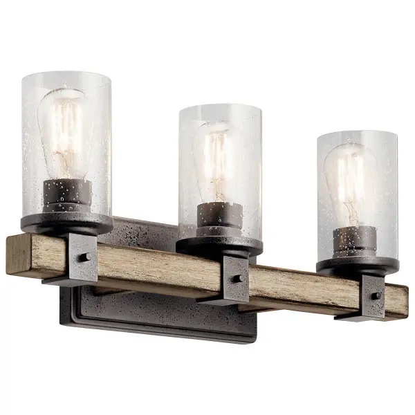 The Barrington 3-Light Vanity Light combines rustic industrial style with practical bathroom illumination. Its anvil iron finish and clear seeded glass shades create character while providing ample light for grooming tasks.
