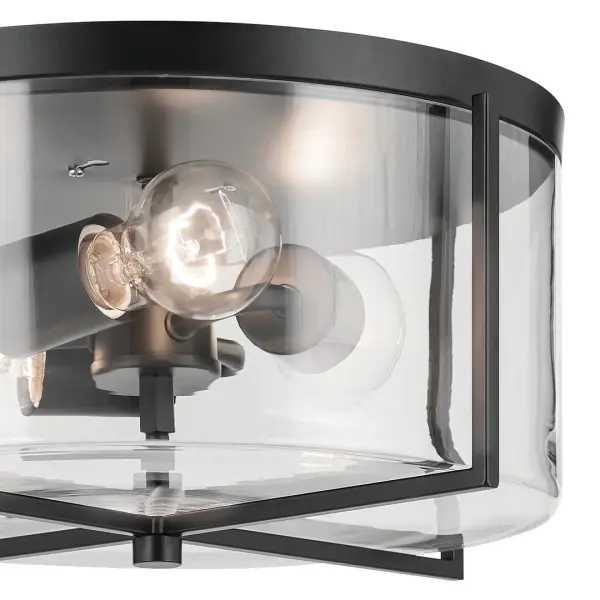 The Birk 3-light flush mount combines industrial style with practical functionality. Its matte black finish and clear glass shades create visual interest while the compact 14-inch diameter fits smaller spaces perfectly. - alternate view
