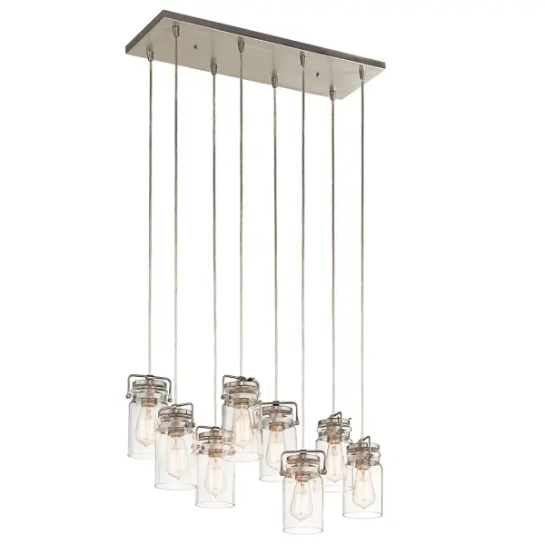 The Brinley 8-Light Linear Chandelier combines clean lines with classic styling, featuring clear glass shades and a brushed nickel finish. Perfect for modern dining rooms and kitchen islands seeking sophisticated illumination.