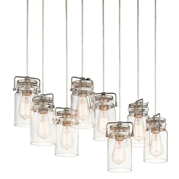 The Brinley 8-Light Linear Chandelier combines clean lines with classic styling, featuring clear glass shades and a brushed nickel finish. Perfect for modern dining rooms and kitchen islands seeking sophisticated illumination. - alternate view