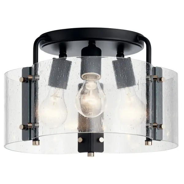 The Thoreau semi-flush mount combines industrial aesthetics with minimalist design through exposed bolts and seeded glass. Its compact 14-inch profile and black steel construction make it versatile across multiple décor styles.