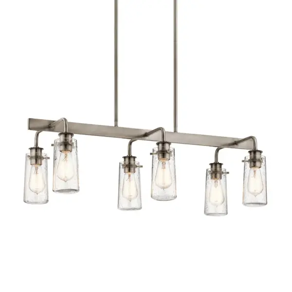 The Braelyn Linear Chandelier combines transitional styling with farmhouse appeal through its Classic Pewter finish and clear seeded glass shades. The 6-light linear design provides excellent illumination over dining tables and kitchen islands.