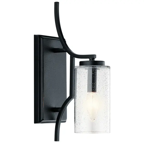 The Vara wall sconce brings refined mission styling with distressed black ironwork and seeded glass. Its compact 4.5-inch width makes it ideal for narrow spaces while the linear detailing adds architectural interest.