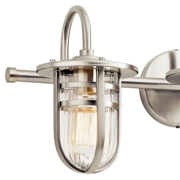 The Caparros vanity light combines transitional styling with functional illumination. Its 32-inch width makes it ideal for double vanities, while the ribbed glass shades add visual texture and diffuse light beautifully. - alternate view