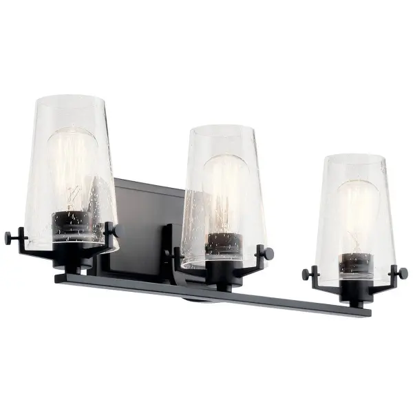 The Alton vanity light combines transitional styling with industrial accents, featuring clear seeded glass shades and a sleek black finish. At 24 inches wide, it's perfectly sized for medium vanities and offers flexible up or down mounting.