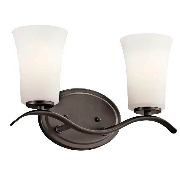 The Armida 2-Light Vanity Light combines traditional styling with practical functionality. Its Olde Bronze finish and clear satin etched glass shades provide warm, diffused illumination perfect for bathroom tasks.